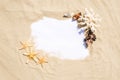 Frame with seashells, coral and starfish on golden sandy beach. Summer vacation concept with copyspace for text message Royalty Free Stock Photo