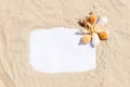 Frame with seashells and starfish on golden sandy beach. Summer vacation concept with copyspace for text message Royalty Free Stock Photo