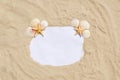 Frame with seashells and starfish on golden sandy beach. Summer vacation concept with copyspace for text message Royalty Free Stock Photo