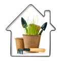 Frame in shape houses with economic stock and tools for gardening. Peat pot with seedlings, shovel and rake isolated