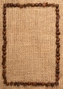 Frame shaped from roasted coffee beans on burlap Royalty Free Stock Photo