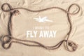 Frame of ship rope on sandy beach with I want to fly away lettering