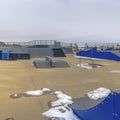 Frame Skate park with various types of ramps under cloudy sky in winter Royalty Free Stock Photo