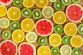 Frame with slice of oranges, lemons, kiwi, grapefruit pattern isolated on wooden background. Flat lay, top view Royalty Free Stock Photo