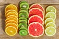 Frame with slice of oranges, lemons, kiwi, grapefruit pattern  on wooden background. copy space Royalty Free Stock Photo