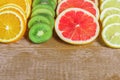 Frame with slice of oranges, lemons, kiwi, grapefruit pattern  on wooden background. copy space Royalty Free Stock Photo