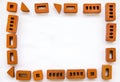 Frame of small bricks on a white background. Space for text. Royalty Free Stock Photo