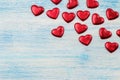 Frame of small red hearts on a blue wooden flne. view from above. place for text. Valentine`s Day Royalty Free Stock Photo