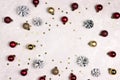 Frame of snow painted pine cones, balls and stars on a light marble background Royalty Free Stock Photo