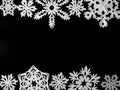Frame of snowflakes cut out of white paper on a black background. Handmade new year and Christmas decoration, copy space Royalty Free Stock Photo