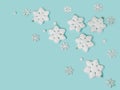 Frame of snowflakes on light blue background, pastel colors Christmas holiday composition top view, copy space, flat lay Royalty Free Stock Photo