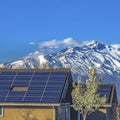 Frame Solar panels installed on the roof of home against snowy mountain and blue sky Royalty Free Stock Photo