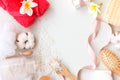 Frame of spa theme objects on white background. Bath salt, comb, pink towels and cotton flower with copy space. Royalty Free Stock Photo