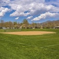 Frame Square Baseball or softball field with buildings and trees beyond the grassy terrain Royalty Free Stock Photo