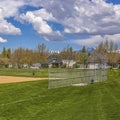 Frame Square Baseball or softball field with buildings and trees beyond the grassy terrain Royalty Free Stock Photo