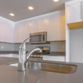 Frame Square Modern kitchen of a new home with close up on the shiny faucet and sink Royalty Free Stock Photo