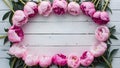 Frame Stunning pink peonies arranged on white rustic wooden background