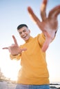 Frame, summer and a man with hands at the beach with happiness, freedom and creativity. Smile, portrait and a young Royalty Free Stock Photo