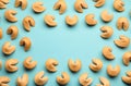 Frame of tasty fortune cookies with predictions on light blue background, flat lay. Space for text Royalty Free Stock Photo