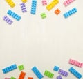 Frame of toy colored plastick bricks on light wooden background Royalty Free Stock Photo