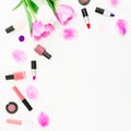 Frame of tulips flowers and cosmetics on white background. Top view. Flat lay. Beauty feminine desk composition. Royalty Free Stock Photo