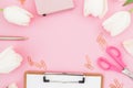 Frame with tulips flowers, mug of coffee, clipboard, clips and glasses on pink background. Blogger concept. Flat lay, top view. Royalty Free Stock Photo