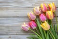 Frame of tulips on rustic wooden background with copy space for greetings card Royalty Free Stock Photo