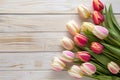 Frame of tulips on rustic wooden background with copy space for greetings card Royalty Free Stock Photo