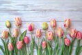 Frame of tulips on rustic wooden background with copy space for greetings card Royalty Free Stock Photo