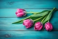 Frame of tulips on turquoise rustic wooden background. Spring flowers. Neural network AI generated Royalty Free Stock Photo