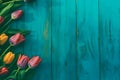 Frame of tulips on turquoise rustic wooden background. Spring flowers. Neural network AI generated Royalty Free Stock Photo