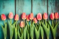 Frame of tulips on turquoise rustic wooden background. Spring flowers. Neural network AI generated Royalty Free Stock Photo