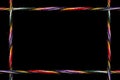 A frame of twisted multi-colored sewing thread on a black background. There is plenty of room for copy or a picture