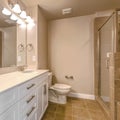 Frame Vanity with double sink adjacent to the toilet inside a well lit bathroom Royalty Free Stock Photo