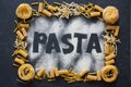 Frame of variety italian pasta on black stone background