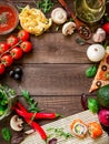 Frame with vegetables, pizza, sushi rolls, tomato, pasta, olives and sauce on wooden background. Food concept for menu. Flat lay. Royalty Free Stock Photo