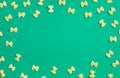 Frame from wheat pasta on green background Royalty Free Stock Photo