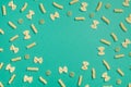 Frame from wheat pasta on green background Royalty Free Stock Photo