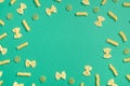 Frame from wheat pasta on green background Royalty Free Stock Photo