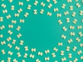 Frame from wheat pasta on green background Royalty Free Stock Photo