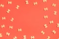 Frame from wheat pasta on red background Royalty Free Stock Photo