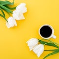 Frame of white tulips flowers with mug of coffee on yellow background. Floral concept. Flat lay, top view. Royalty Free Stock Photo