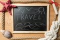 Frame with word Travel on blackboard decorated by marine objects