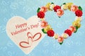 Frame and wreath of roses in the shape of a heart on a blue textured wooden background, bokeh with hearts Royalty Free Stock Photo