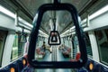 Framed capture of empty train cabin interior; shot through support hand holds; creative angle; composition Royalty Free Stock Photo