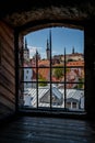 Framed cityscape view of Tallinn, Estonia looking through medieval tower stone