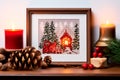 A framed embroidered christmas card with ornaments and candles on wooden table. Winter background with pine twigs Royalty Free Stock Photo
