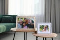 Framed family portraits in living room at home