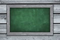 Framed green chalkboard on wood background -. copy space