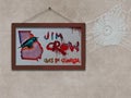 A framed picture of a crow sitting on a map of the state of Georgia, US as a cobweb hangs from the outdated Jim Crow concept in th